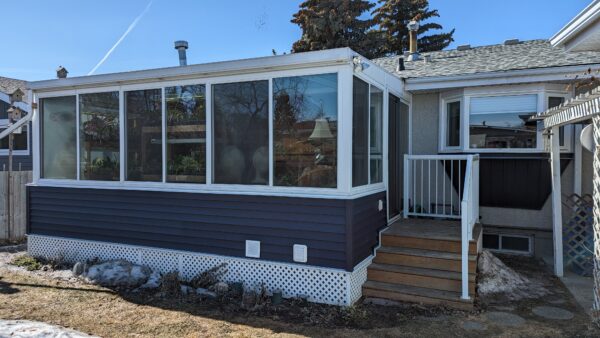 Remove vinyl siding and install new royal Navy Blue siding on sunroom of home