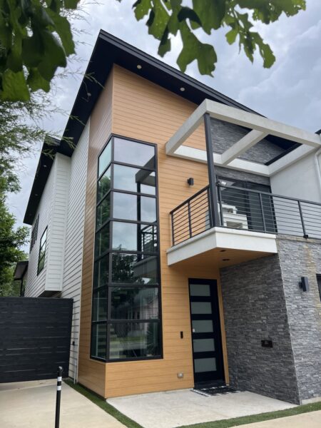 Replaced wood siding with Sagiper SagiWall v groove siding in Caramel Zebra color and front entrance ceiling with SagiRev soffit in same color.