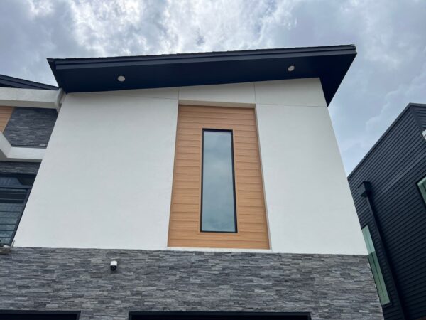 Replaced wood siding with Sagiper SagiWall v groove siding in Caramel Zebra color and front entrance ceiling with SagiRev soffit in same color.